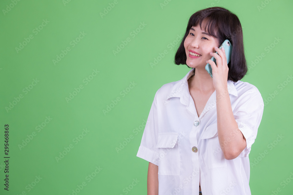Portrait of happy Asian businesswoman talking on the phone Portrait of happy Asian businesswoman talking on the phone