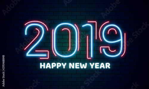 Neon text 2019 Happy New Year on brick wall background can be used as poster or banner design.