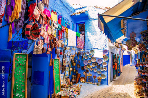 Traditional carpets on the blue Chefchaouen street. © lizavetta