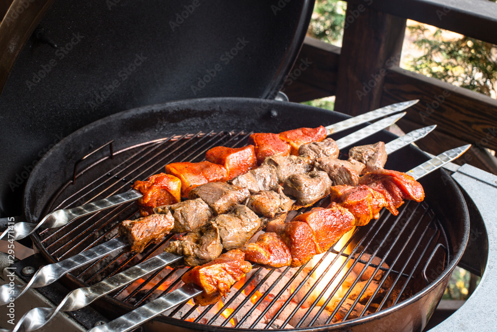 Shashlik on a round barbecue grill.