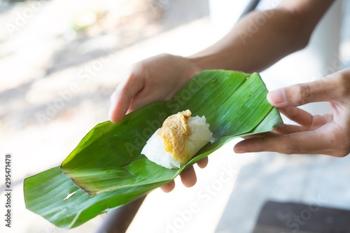 Thai desserts egg  custard with Sticky rice in the banana leaf.