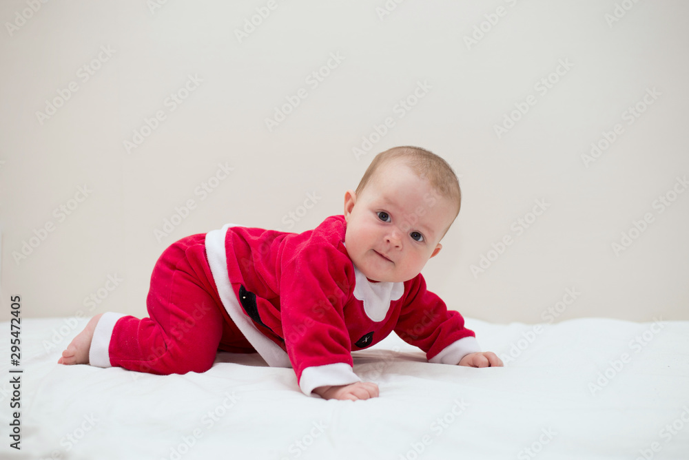 Sweet baby wearing Santa costume, over white background with copy space Sweet baby wearing Santa costume, over white background with copy space