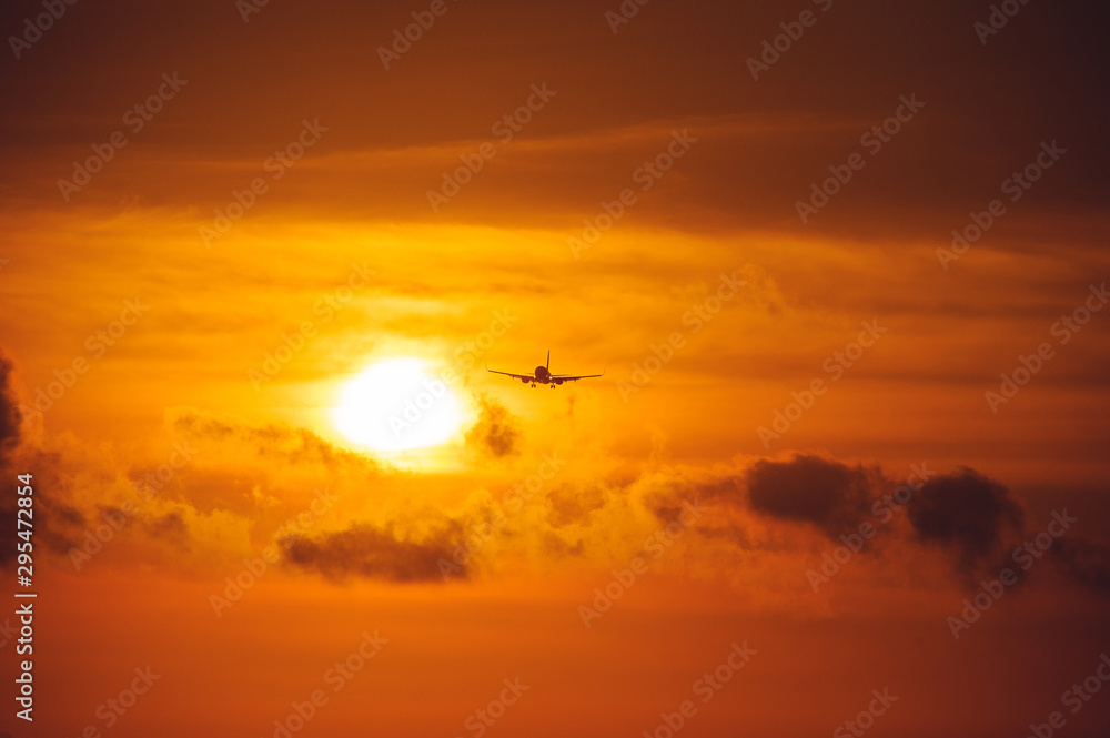 Silhouette of a passenger airliner in the sky during sunset. Airplane in the sky. Silhouette of a passenger airliner in the sky during sunset. Airplane in the sky.