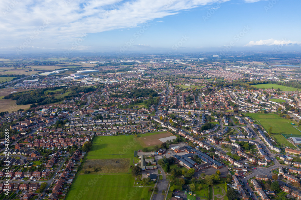 Aerial photo of the town of Castleford in the district of Wakefield in the UK, showing roof top view of typical UK rows of houses and streets.