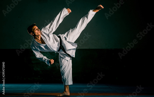 The man in a kimono practicing karate moves photo