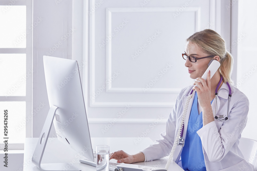 Portrait of a happy smiling young doctor in headset in office Portrait of a happy smiling young doctor in headset in office