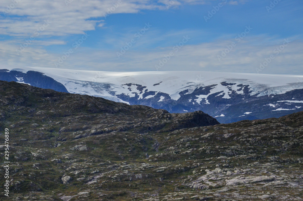 Landscape photo of the trail path to the cliff Trolltunga in the Norwegian mountains. Landscape photo of the trail path to the cliff Trolltunga in the Norwegian mountains.