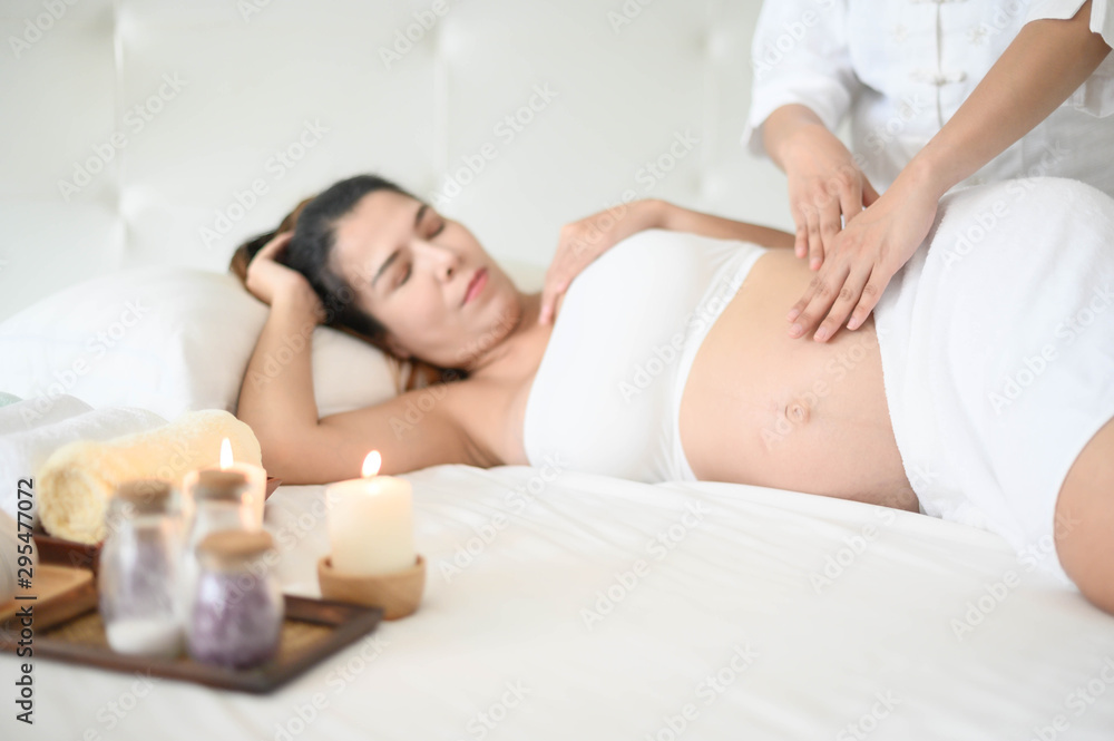 pregnant woman having massage in spa relax , a massage to the belly of a pregnant girl pregnant woman having massage in spa relax , a massage to the belly of a pregnant girl