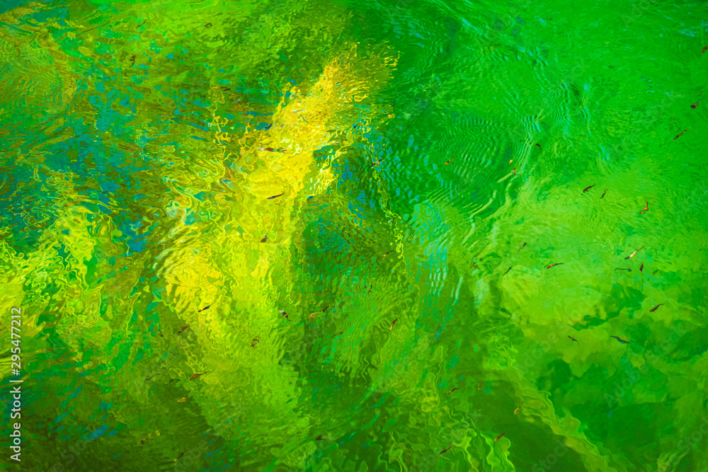 Green, blue and yellow reflections in the river. Abstract colorful background Green, blue and yellow reflections in the river. Abstract colorful background