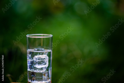 A glass of clean water with ice placed on the table ready to drink