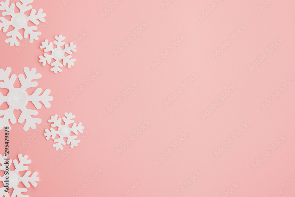 Winter pattern made of snowflakes and on pink background. Christmas concept. Flat lay. Copy space for your text