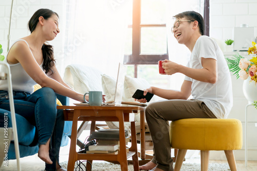 happiness asian couple family marry enjoy morning talk together with love and relation on sofa with laptop and coffee home interior background