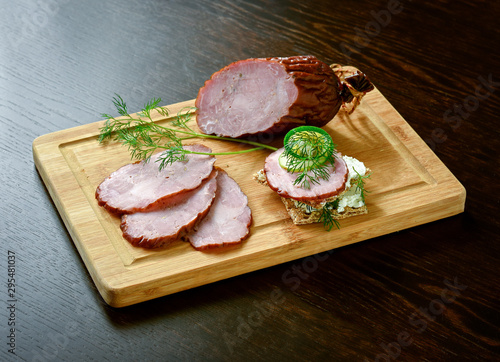 Dried smoked sausage on a wooden board