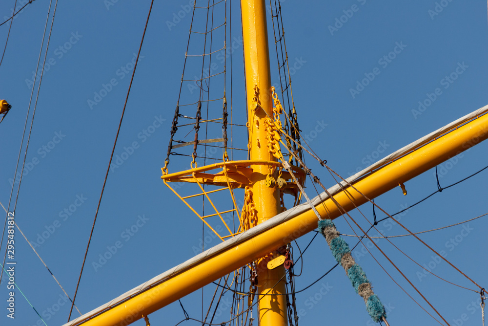 Masts, yards, cables and rigging of a large sailing ship close-up.. Masts, yards, cables and rigging of a large sailing ship close-up..