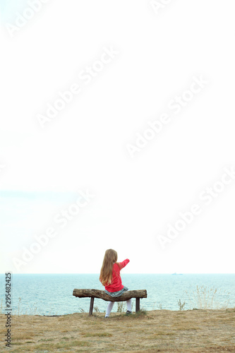 woman sitting on a chair on the beach © KawaiiS