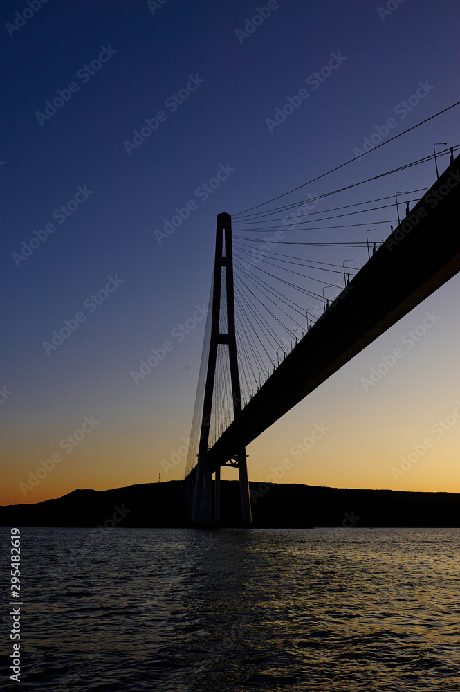 The silhouette of the cable-stayed bridge in Vladivostok, a beautiful view of the sunset The silhouette of the cable-stayed bridge in Vladivostok, a beautiful view of the sunset