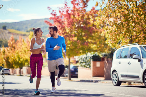 Man and woman enjoying at jogging at city