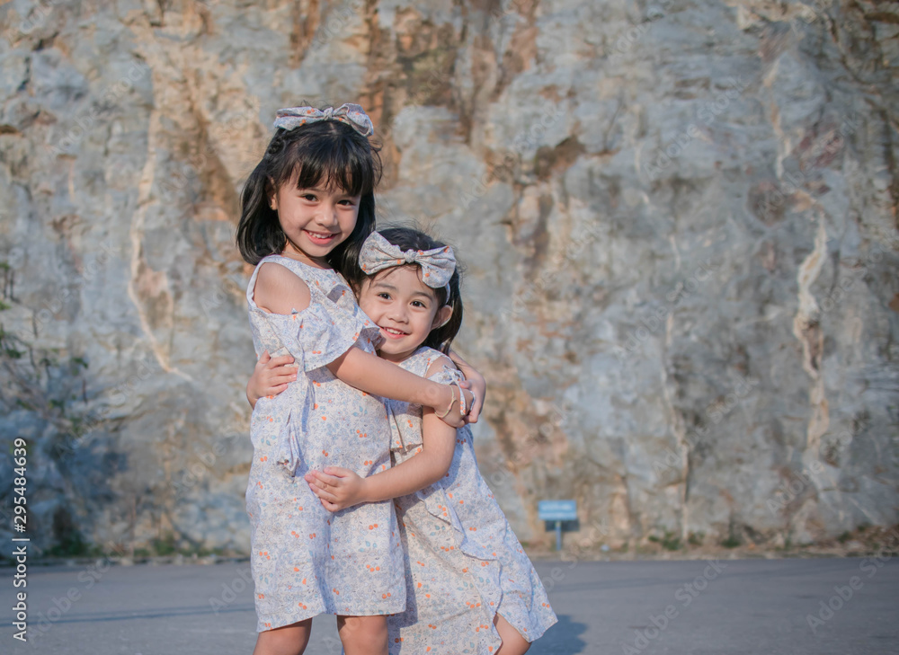 Two asian little child girls hugging Two asian little child girls hugging