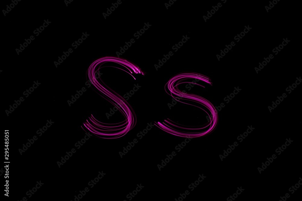 Long exposure photograph of the letter s in pink neon color, in upper case and lower case, parallel lines pattern against a black background. Light painting photography. Long exposure photograph of the letter s in pink neon color, in upper case and lower case, parallel lines pattern against a black background. Light painting photography.