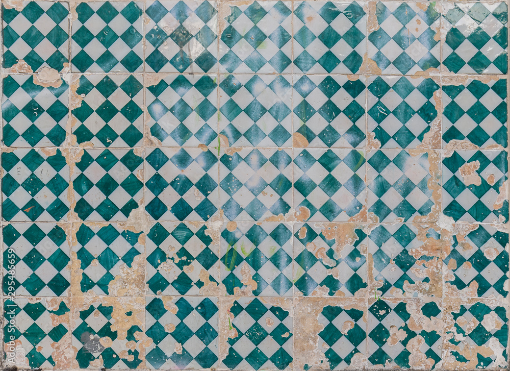 Close-up of an old, weathered and cracked wall with colorful ceramic tiles (azulejos) in Lisbon, Portugal. High resolution full frame textured background. Close-up of an old, weathered and cracked wall with colorful ceramic tiles (azulejos) in Lisbon, Portugal. High resolution full frame textured background.