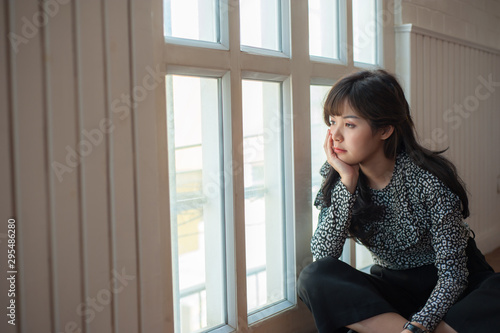 Free Download The woman who was absent-minded and sorrowful, sat looking out the window. - GFXLoad
