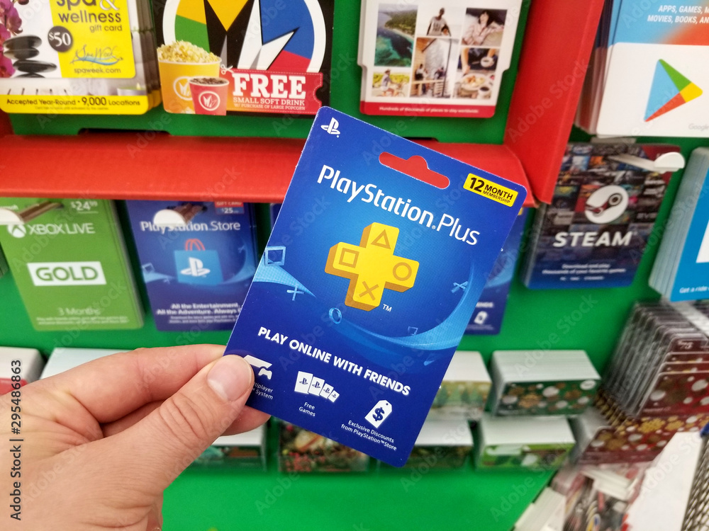 Play Station Plus gift card in a hand Stock Photo | Adobe Stock