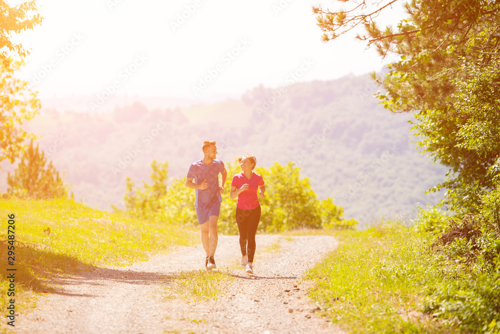 young couple jogging on sunny day at nature young couple jogging on sunny day at nature