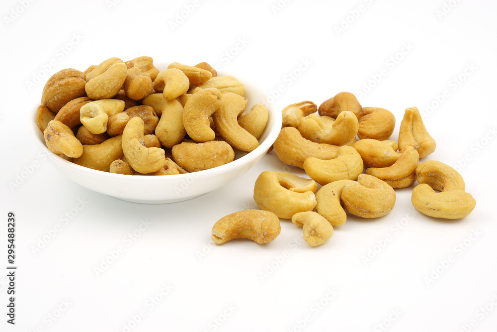 Roasted cashew nuts with salt in dish isolate on white background Roasted cashew nuts with salt in dish isolate on white background