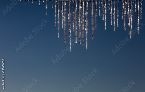 Winter icicles on a background of the early sun frosty morning