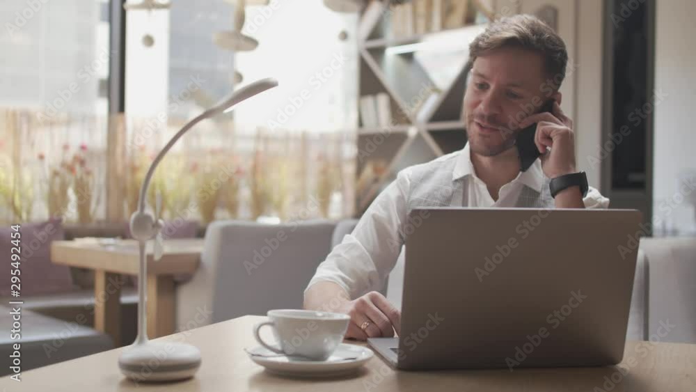 Businessman sitting and working in a cafe. Man using computer devices. Business and entrepreneurship. Businessman sitting and working in a cafe. Man using computer devices. Business and entrepreneurship.