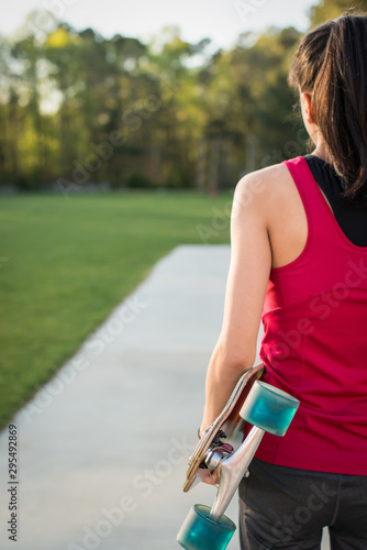Girl getting ready to skateboard at a local park