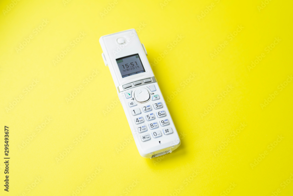 landline phone on a yellow background close-up landline phone on a yellow background close-up