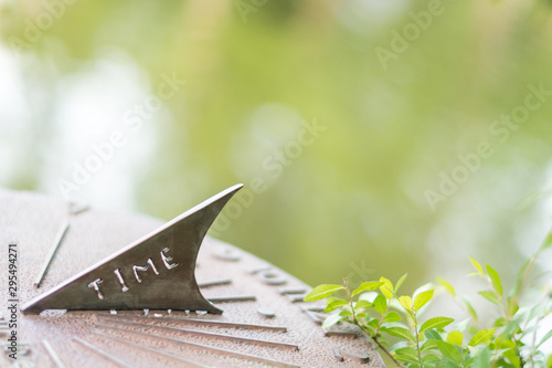 Sun dial in a garden on a spring day