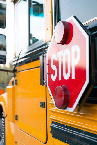 Yellow public school bus with red stop sign