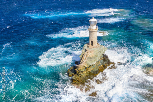 The beautiful Lighthouse Tourlitis of Chora in Andros island and a seagull, Cyclades, Greece