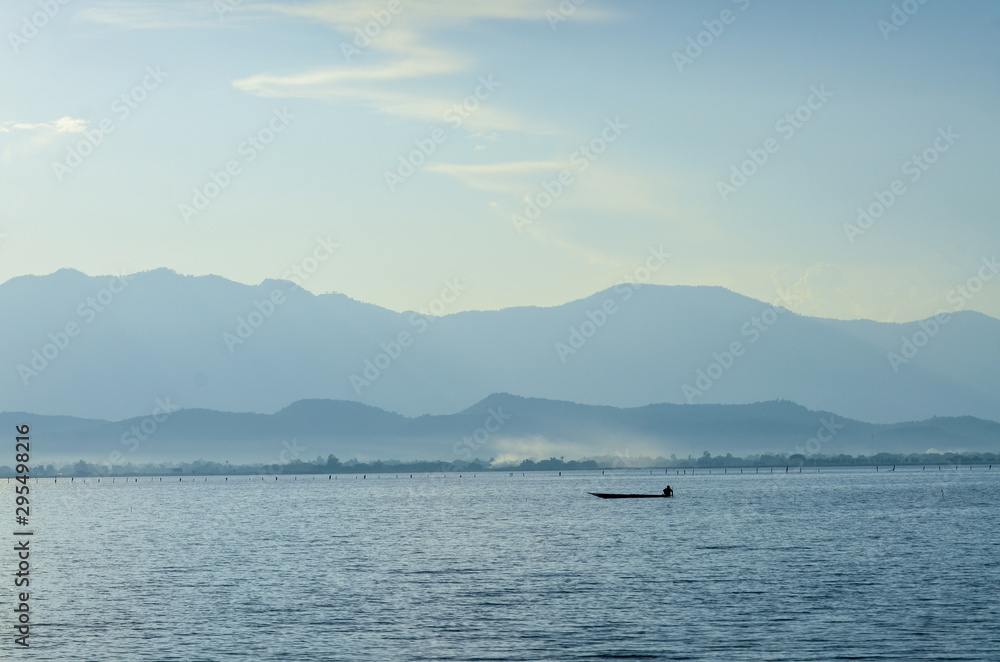 peaceful of lake with mountain view at Phayao lake in Thailand peaceful of lake with mountain view at Phayao lake in Thailand