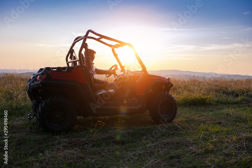 portrait of young man driving a off road buggy car photo
