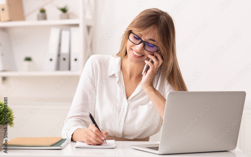 Cheerful Businesswoman Talking On Cellphone Sitting In Modern Office Cheerful Businesswoman Talking On Cellphone Sitting In Modern Office