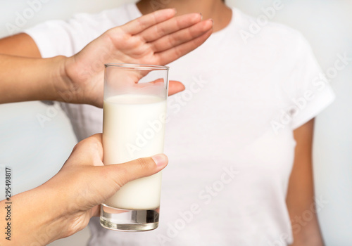 Unrecognizable Girl Gesturing No To Milk Glass, White Background, Cropped