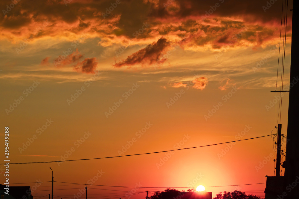 Beautiful abstract colorful background. Dramatic sunset like fire in the sky with golden and red clouds. Selective focus