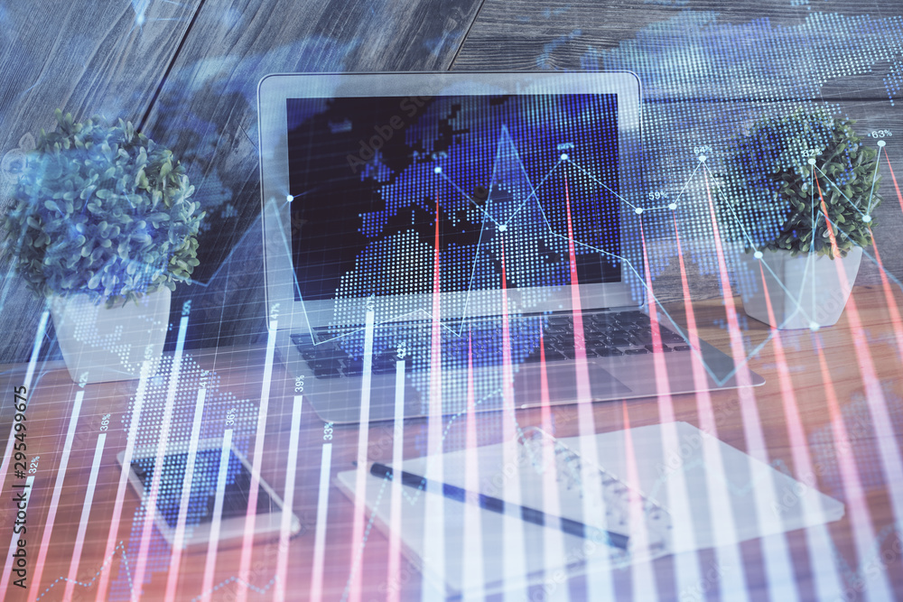 Financial graph colorful drawing and table with computer on background. Double exposure. Concept of international markets. Financial graph colorful drawing and table with computer on background. Double exposure. Concept of international markets.