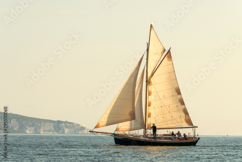 Old sailing boat all sails outside on the sea