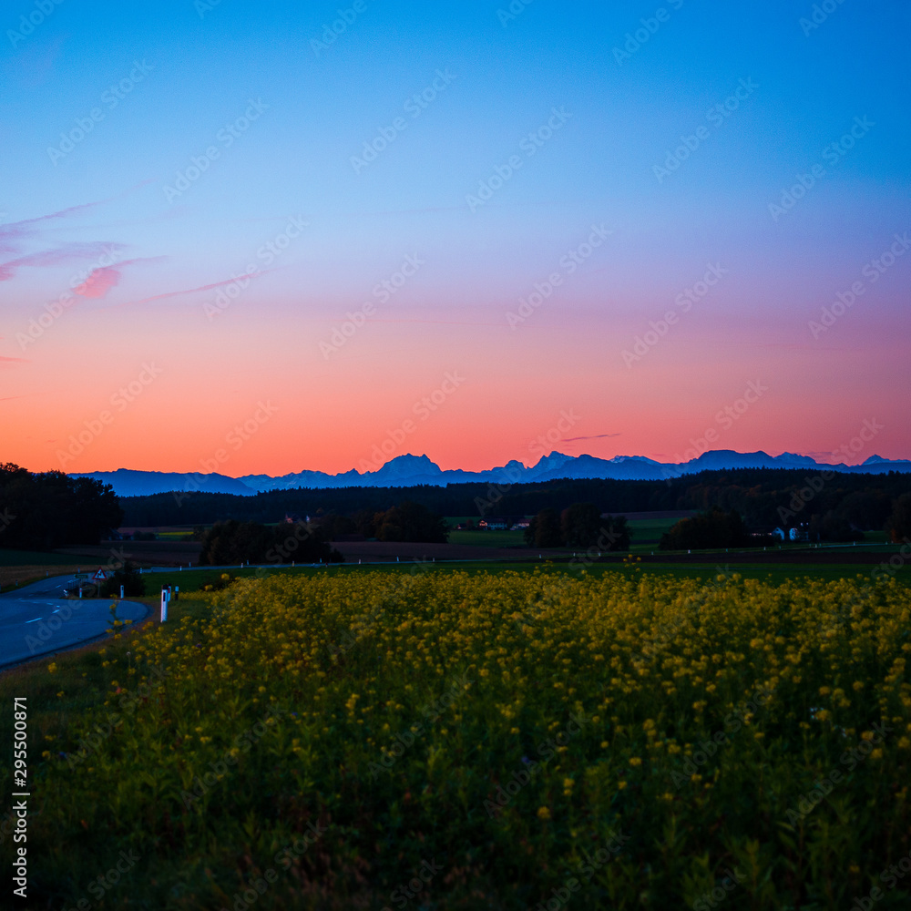 Scenic view of countryside with the Austrian alps in the background early in the morning.