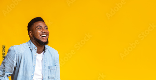 Black man looking at copy space with ecstatic face expression photo