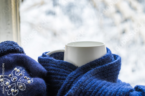 Cup Of Hot Coffee Or Tea In Blue Knitted Scarf And Mittens With Pattern.