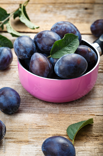 plums on wooden background