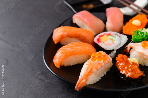 close up of sashimi sushi set on black dish,