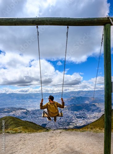 Swing with Quito city in the background. Ecuador.