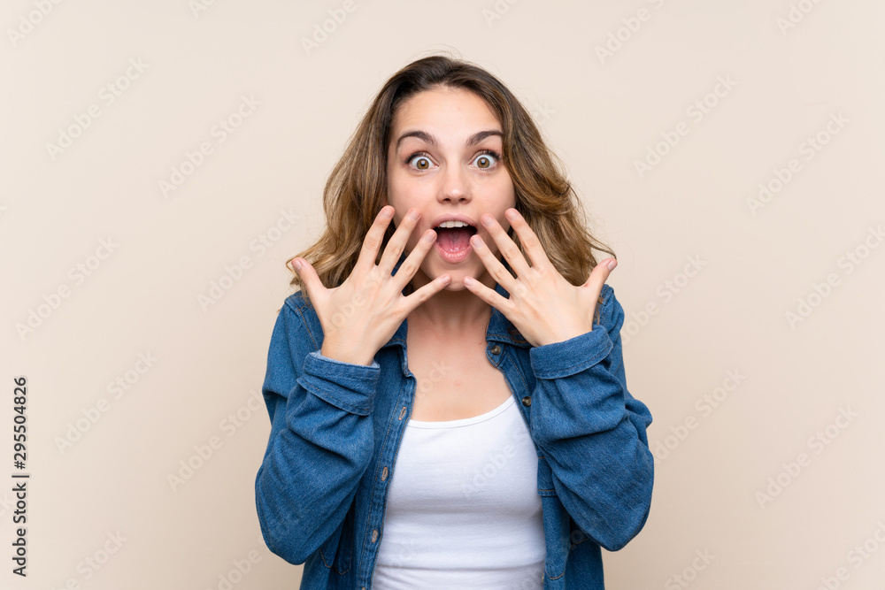 Young blonde woman over isolated background with surprise facial expression Young blonde woman over isolated background with surprise facial expression
