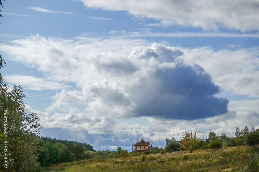 Rain clouds over the field. Autumn landscape. Russia